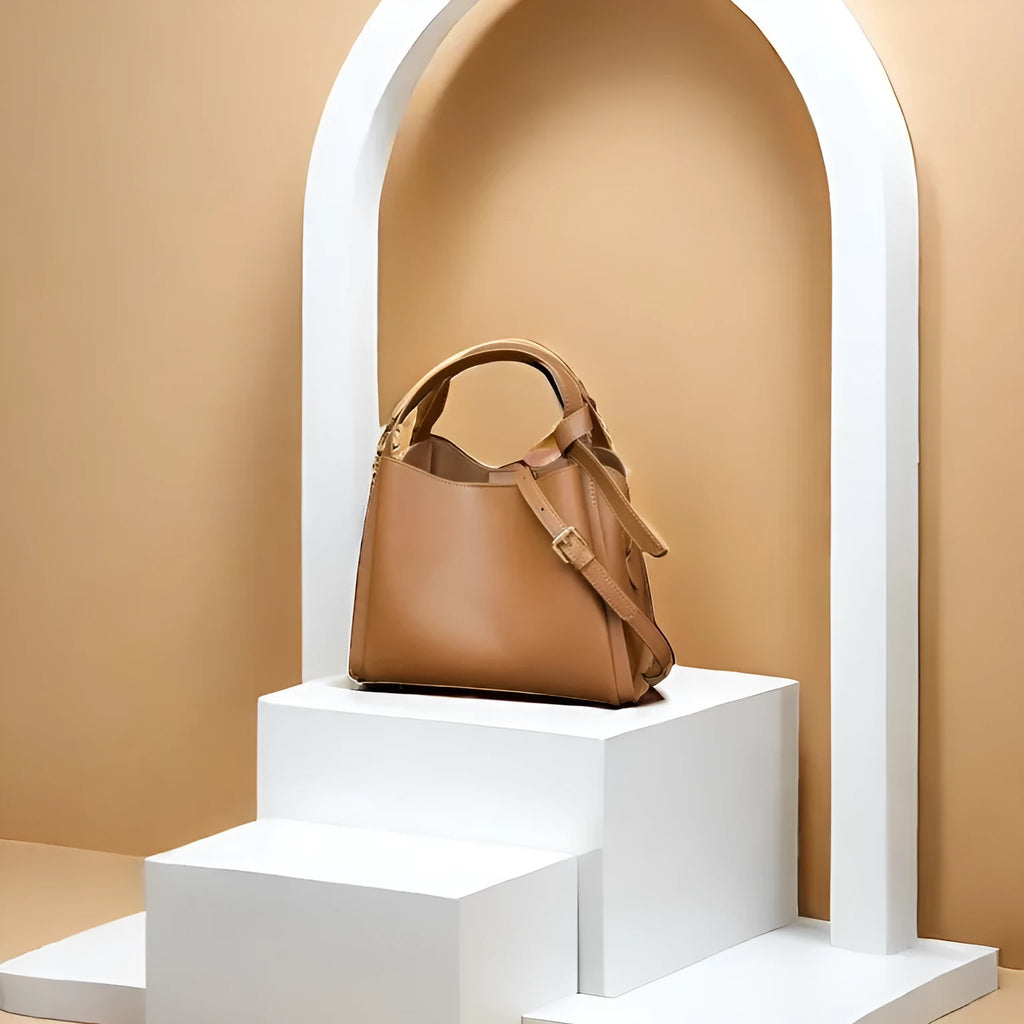 Women's tea brown genuine leather crossbody bucket bag showing internal zipped compartments