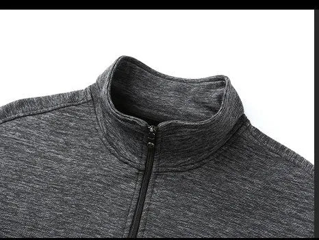 Men's black athletic jacket with stand-up collar and zip front, shown on a model.