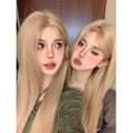 Long straight milk tea blonde synthetic wig on a model, shown with an included hair net.
