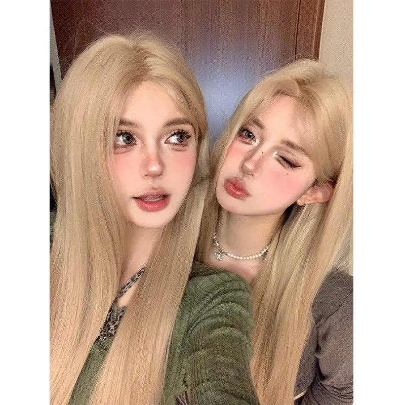 Long straight milk tea blonde synthetic wig on a model, shown with an included hair net.