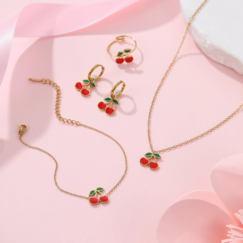 Complete cherry jewellery set with stainless steel necklace, bracelet, earrings, and ring on 18K electroplated chain.