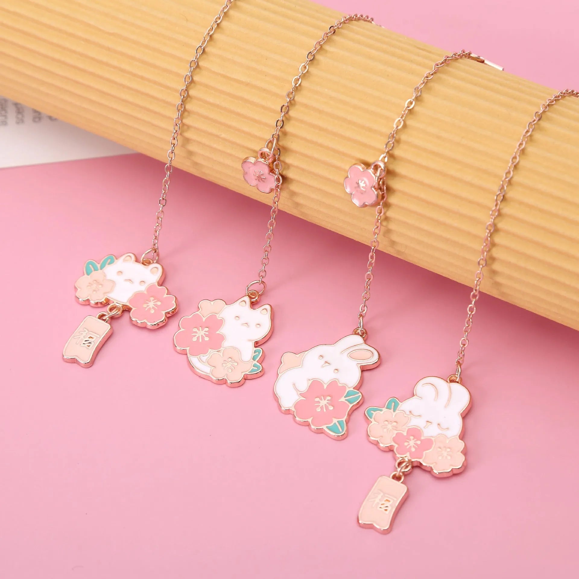 Creative cartoon metal pendant book holder with cherry blossom cat design for journal decoration.