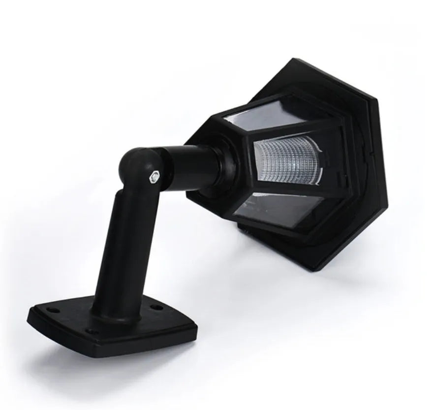 Black hexagonal solar-powered LED wall light for outdoor garden use.