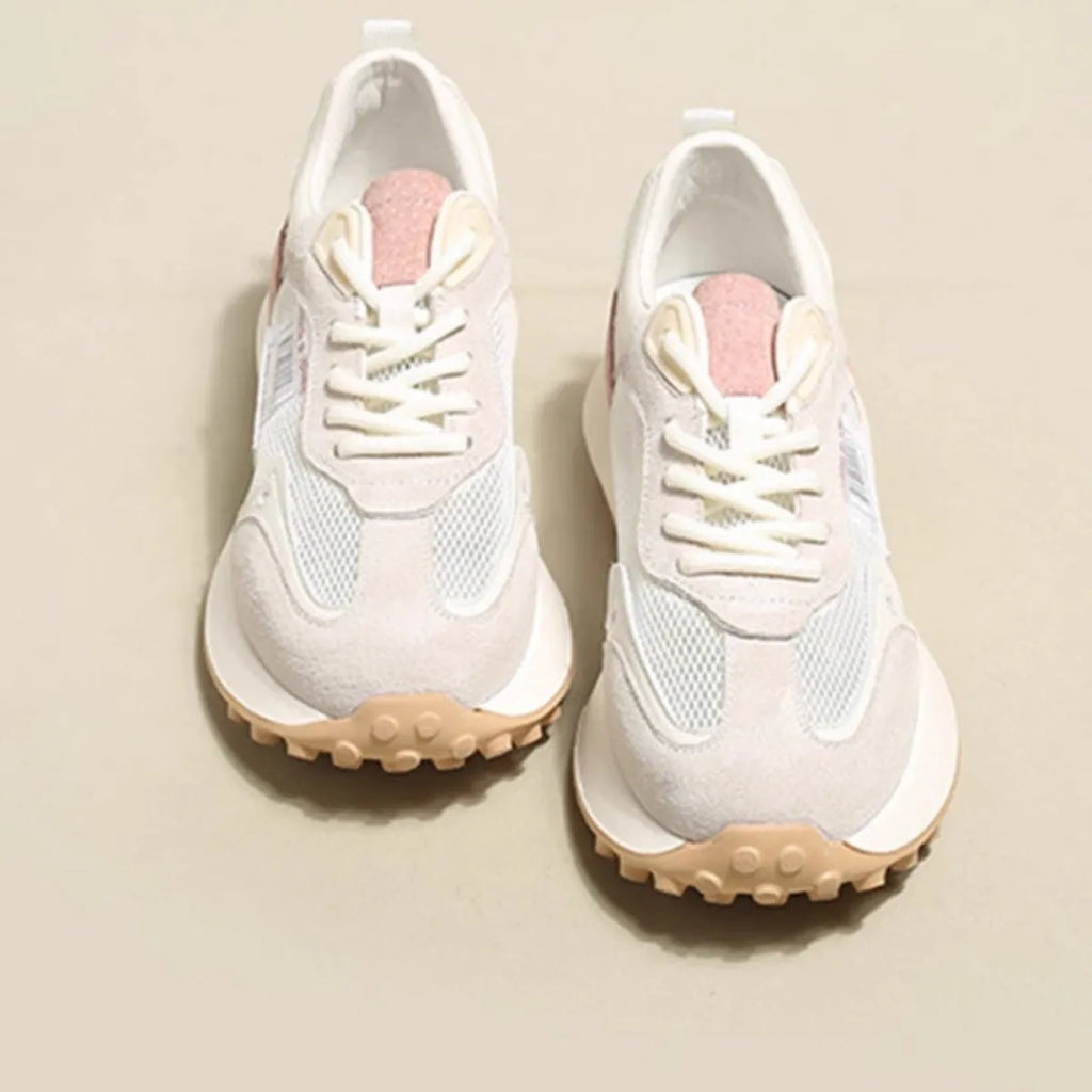 Women's grey and pink low-top retro sneaker with round toe and flat rubber sole.