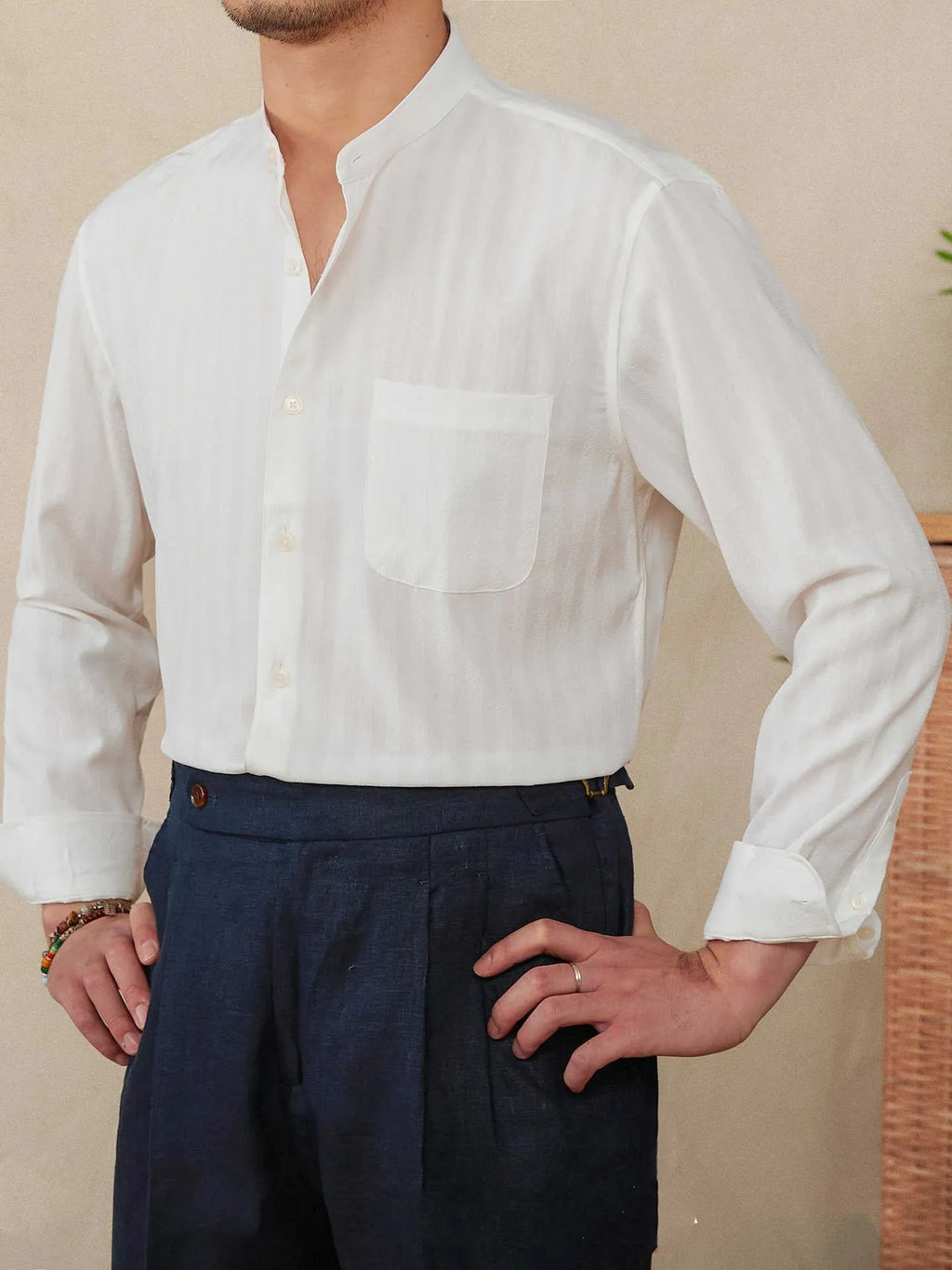 Blue and white seersucker striped long sleeve shirt with loose lapel collar on hanger