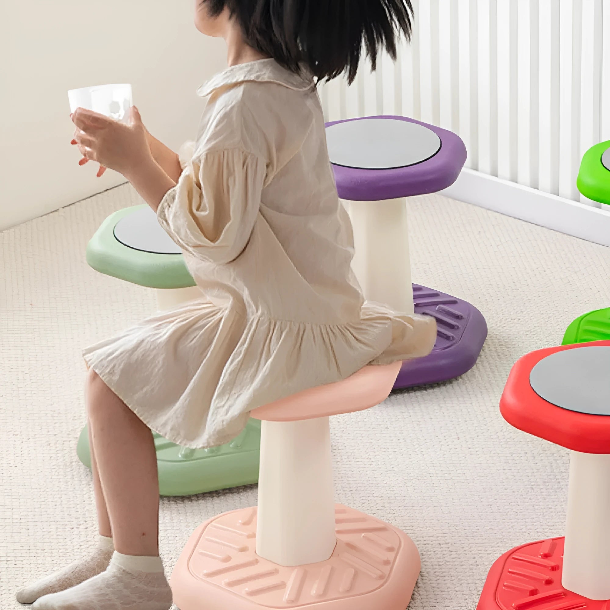 A plastic children's rocking stool for balance training and active sitting, shown in one of seven available colours.