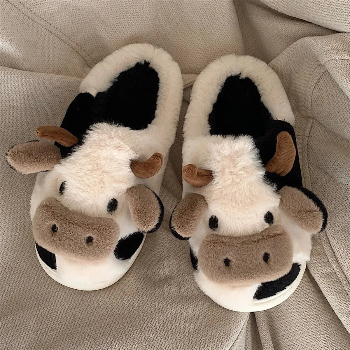 Women's cow slippers with faux fur upper, non-slip PVC sole, and plush lining in white colour