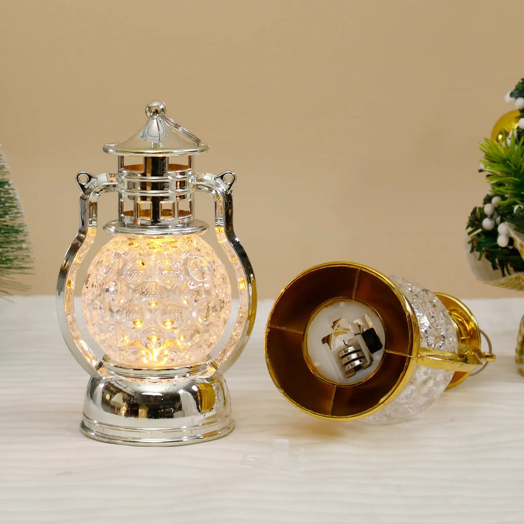 Creative retro-style small oil lamp LED night light in gold or silver finish on a table.