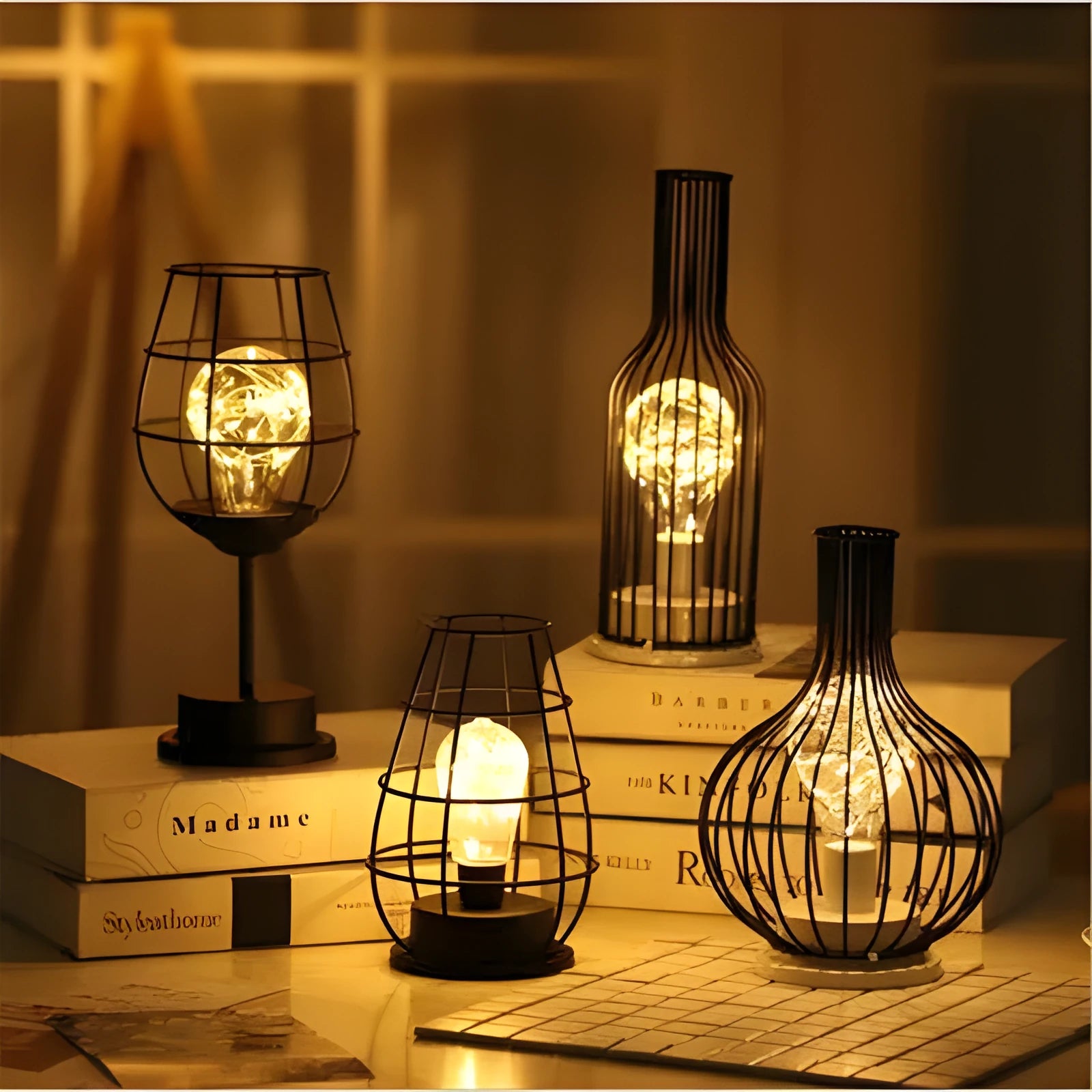 Minimalist hollow iron table lamp in a red wine bottle style with warm white LED light.