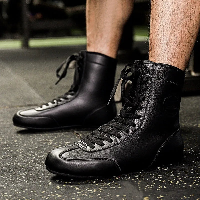 Professional black and gold mesh boxing shoes with leather upper and rubber sole.