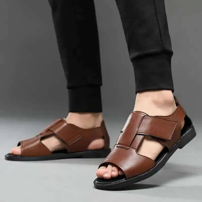 Men's black leather sandals with open-toe design and non-slip rubber soles on a beach background