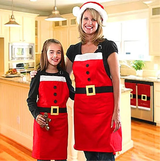 Red Christmas apron for adults and children on a hanger, showing adjustable neck and waist straps.
