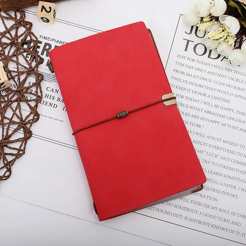 A6 notebook with imitation leather cover in choice of grey, pink, or red, showing cowhide rope style binding.