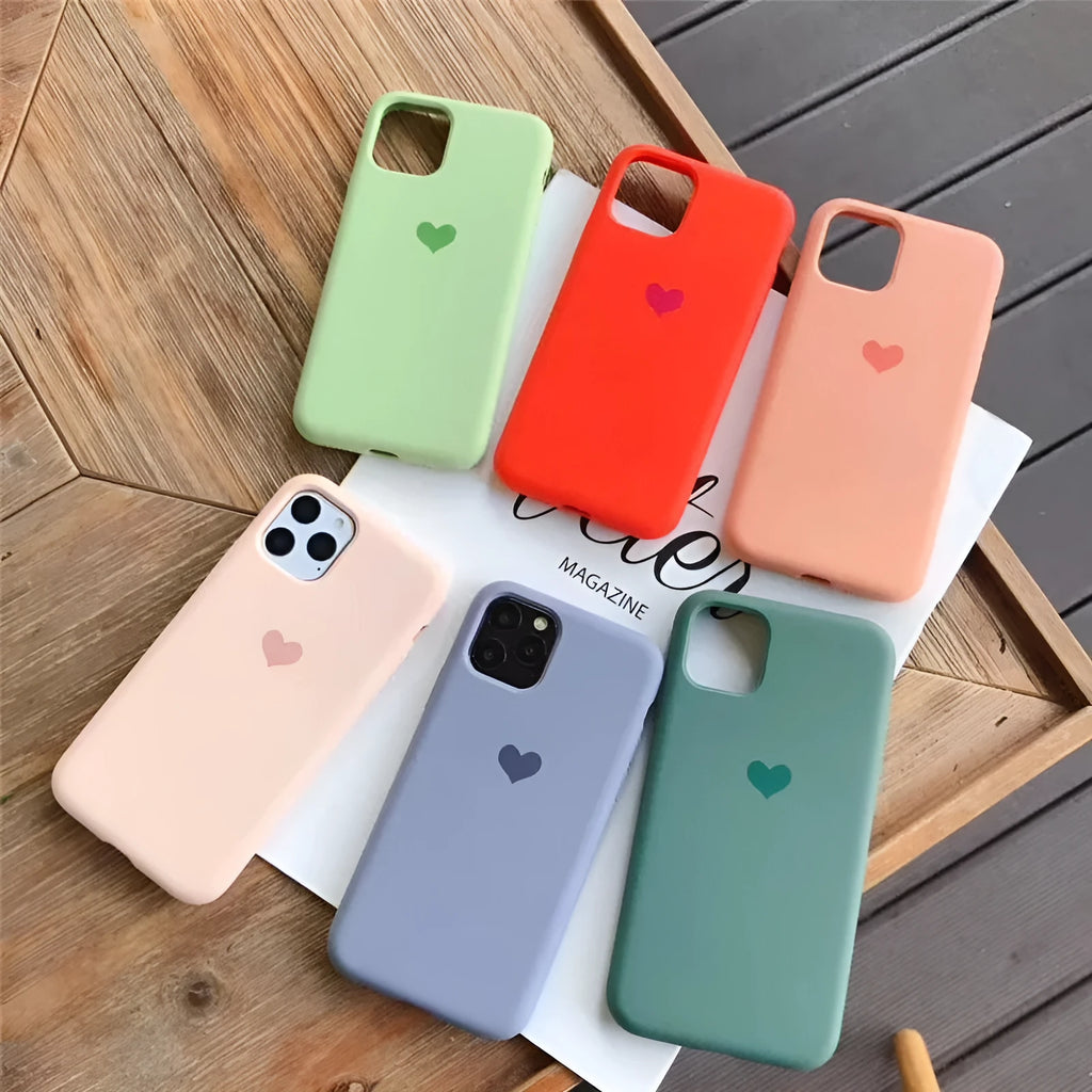 Simple solid-colour silicone phone case for iPhone, shown in a selection of colours including dark green and light pink.