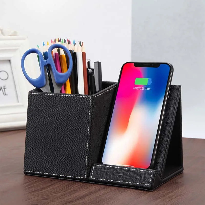 Black leather pen holder wireless charger on desk with phone charging and pens stored