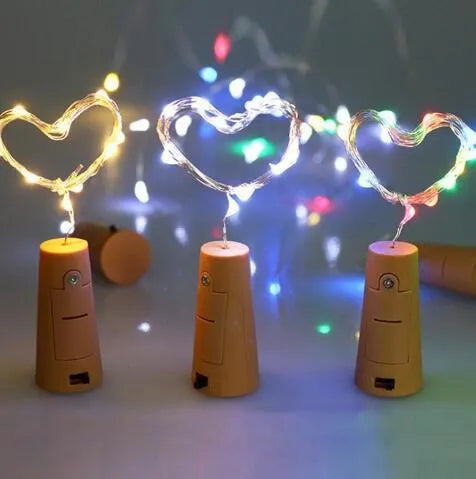 Bendable copper wire LED string lights wrapped around a wine bottle with 20 warm white LEDs glowing