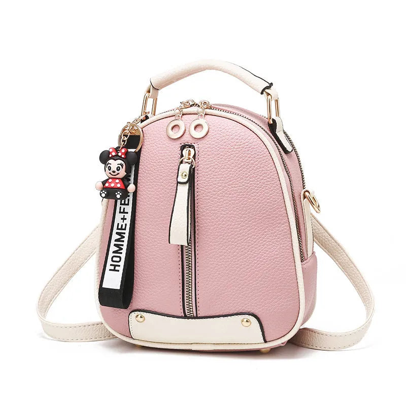 Women's PU leather oval fashion backpack with zip closure, multiple internal pockets and soft handle in white, red, black or pink