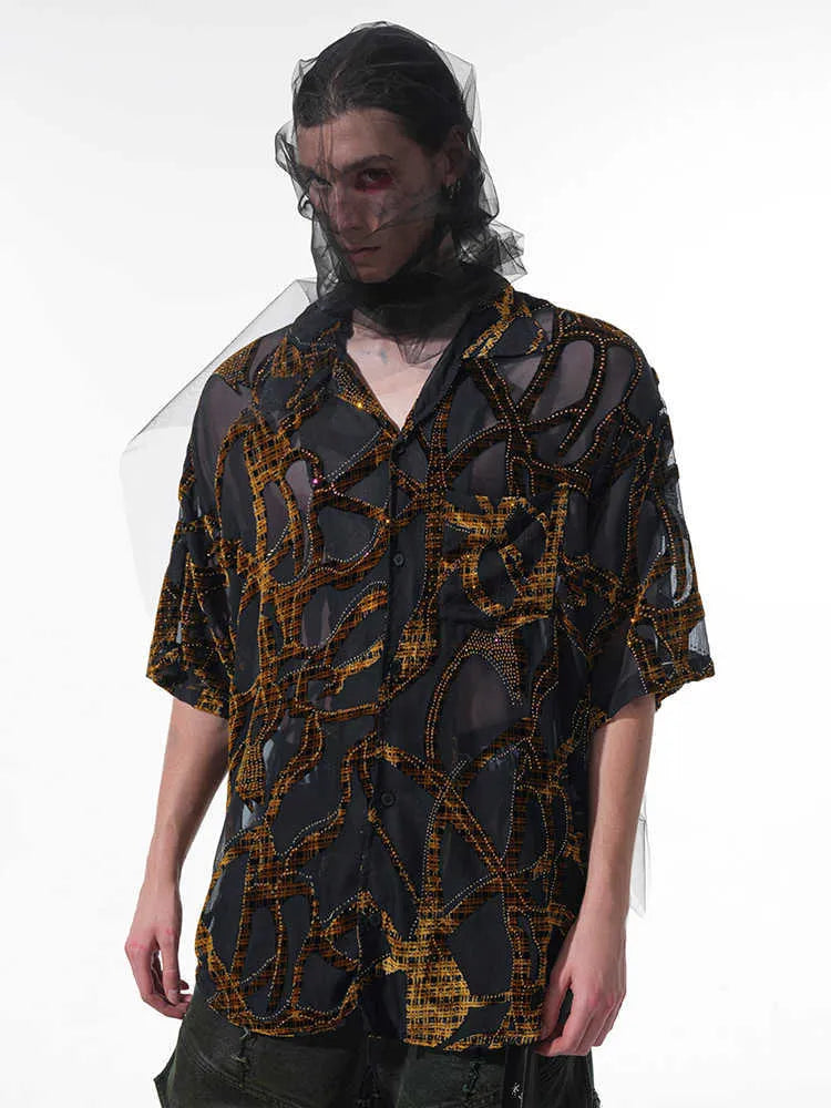 Man wearing a black translucent short-sleeved shirt with a snake pattern, featuring a lapel collar and loose fit.