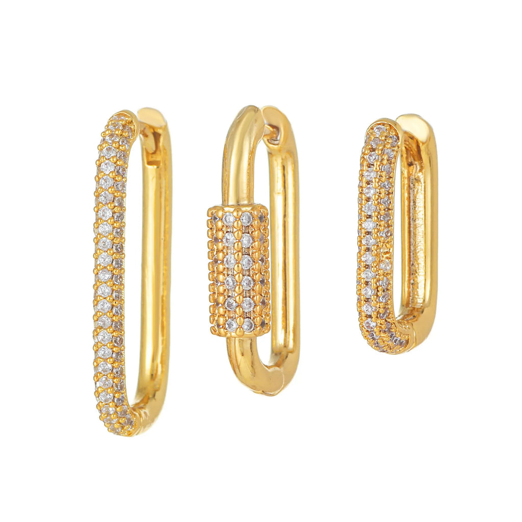 Three geometric copper ear clips with zircon detailing in ellipse and quadrilateral shapes on ear