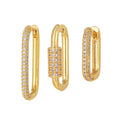 Three geometric copper ear clips with zircon detailing in ellipse and quadrilateral shapes on ear