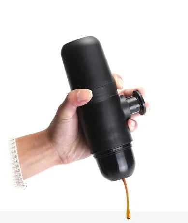 Black portable manual coffee machine showing compact size for travel