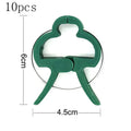 Green plant fixing clips holding tomato vine to support stake without damaging stem