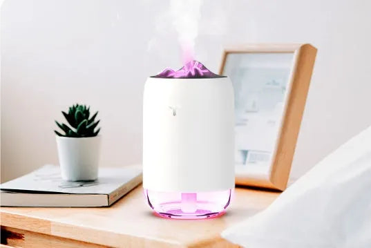 Mini cylindrical USB humidifier with night light in green, showing mist output and USB cable.