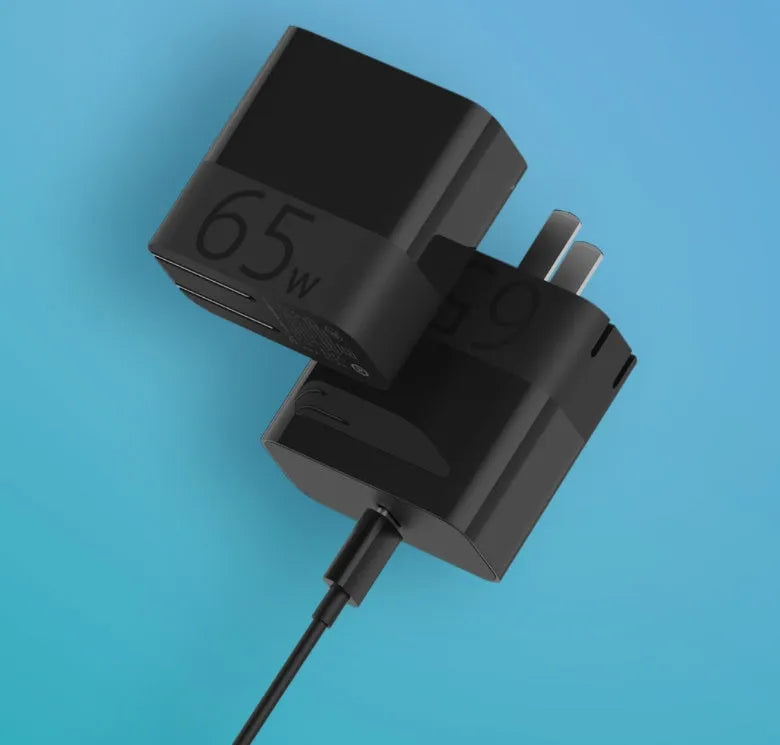 Black ZMI 65W USB-C laptop power adapter showing compact dimensions