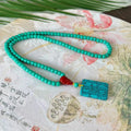 Turquoise mesh flower pendant necklace with adjustable ball bead chain showing hand-woven texture detail