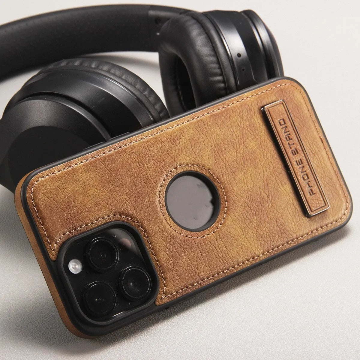 Imitation leather bracket phone case for iPhone 12-15 in black, camel, or dark blue, with built-in stand.