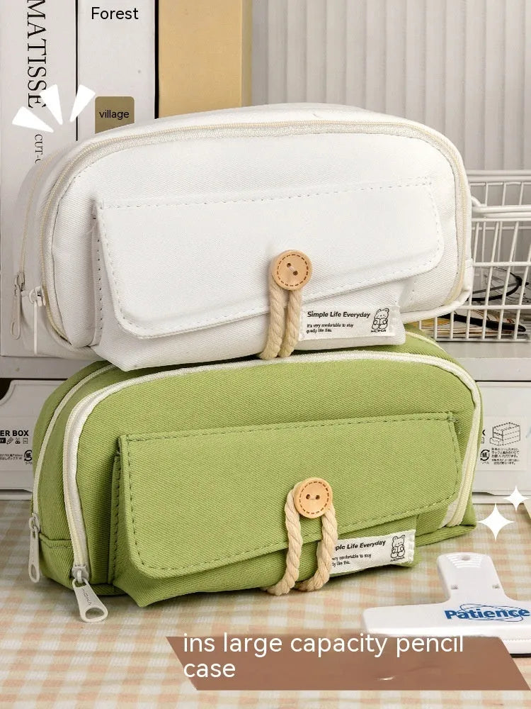Large capacity canvas pencil case in green, beige, blue, and grey colours, holding approximately 80 pens.