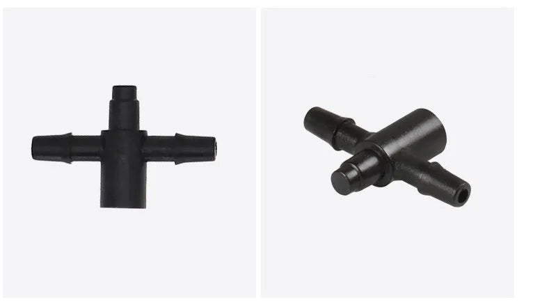Close-up of a black plastic tee joint water distributor for garden irrigation with three screw-thread outlets.