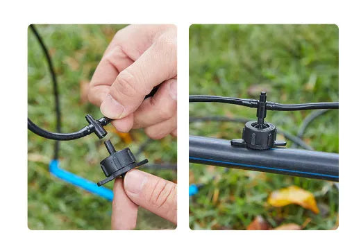 Close-up of a black plastic tee joint water distributor for garden irrigation with three screw-thread outlets.