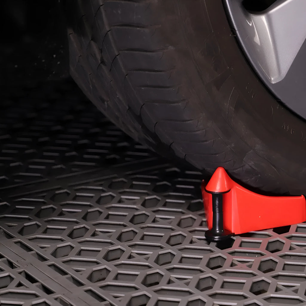 Set of four bright red plastic triangle parking blocks with a non-slip rubber surface.