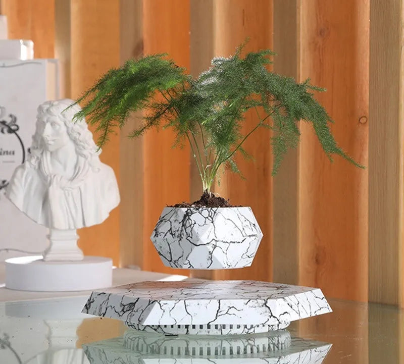 Marble-coloured levitating plant pot floating and rotating with magnetic technology for bonsai or small plants