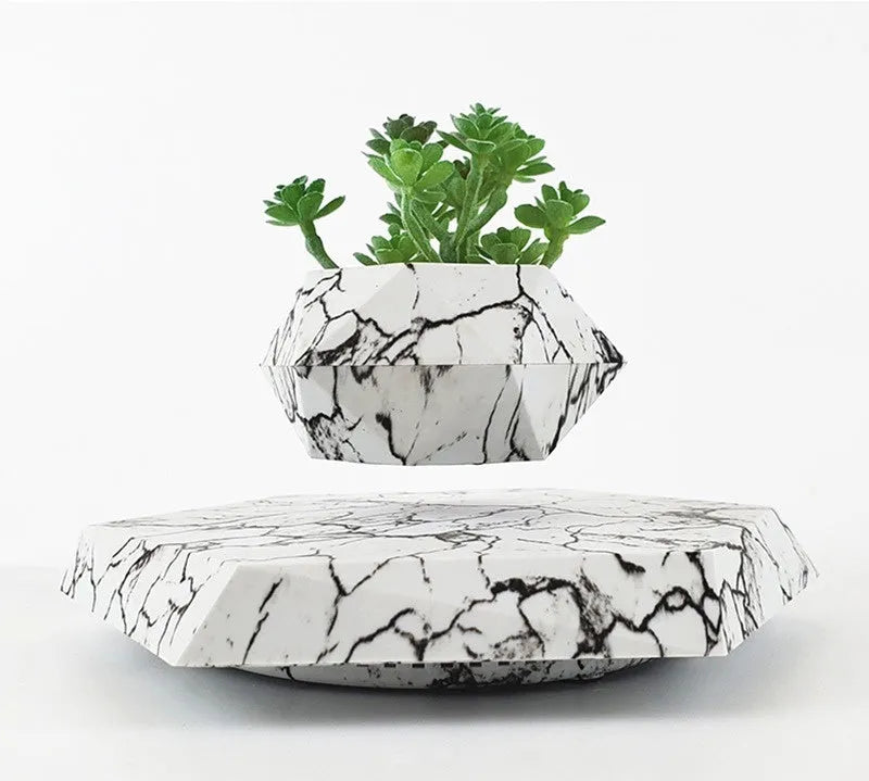 Marble-coloured levitating plant pot floating and rotating with magnetic technology for bonsai or small plants