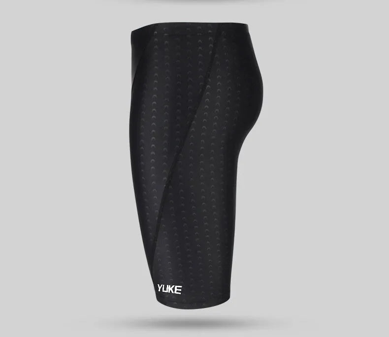 Men's black swimming set with briefs, goggles, cap, ear plugs, nose clip, and a carry bag laid out.