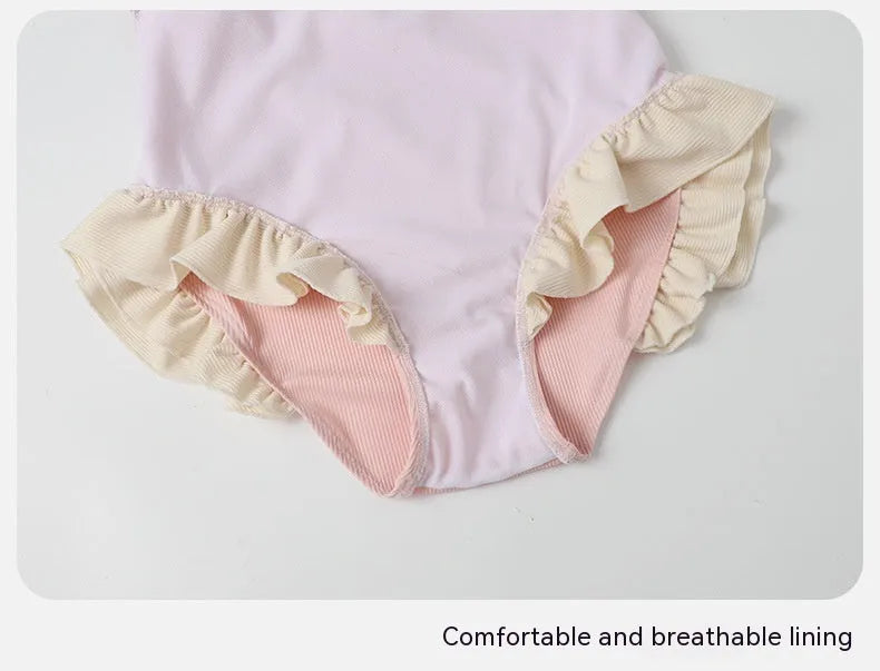 A pink women's conservative one-piece swimsuit on a white background.