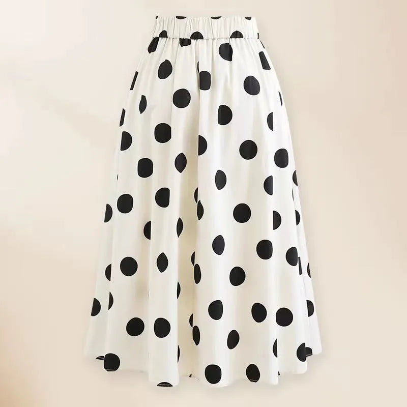 Women's black one-piece swimsuit with matching beach dress featuring bow and round skirt design