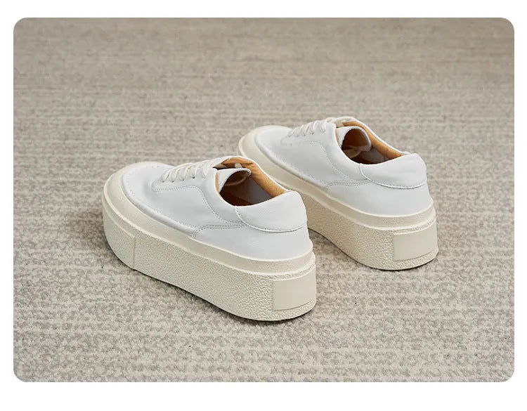Women's black embossed cowhide leather platform sports shoes with white rubber sole and lace-up front.