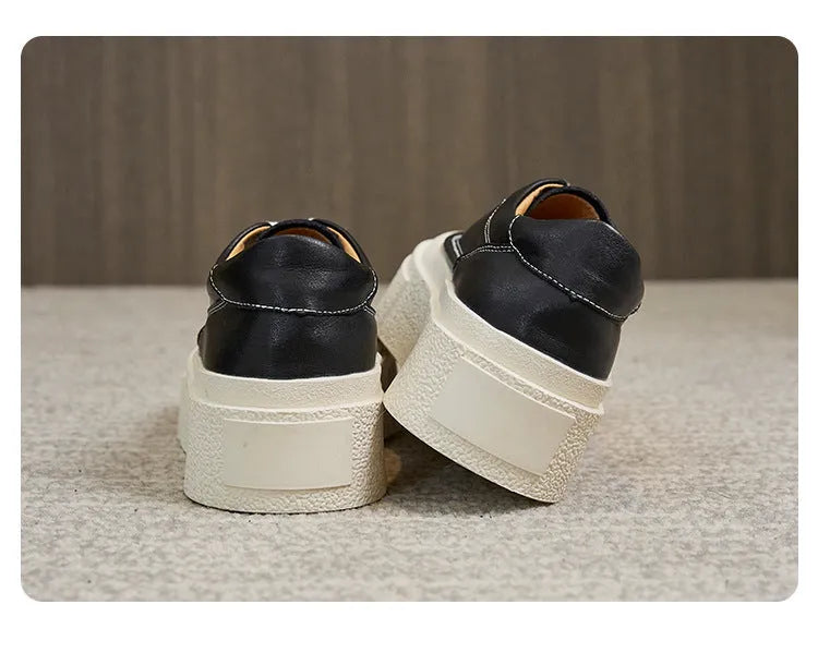 Women's black embossed cowhide leather platform sports shoes with white rubber sole and lace-up front.
