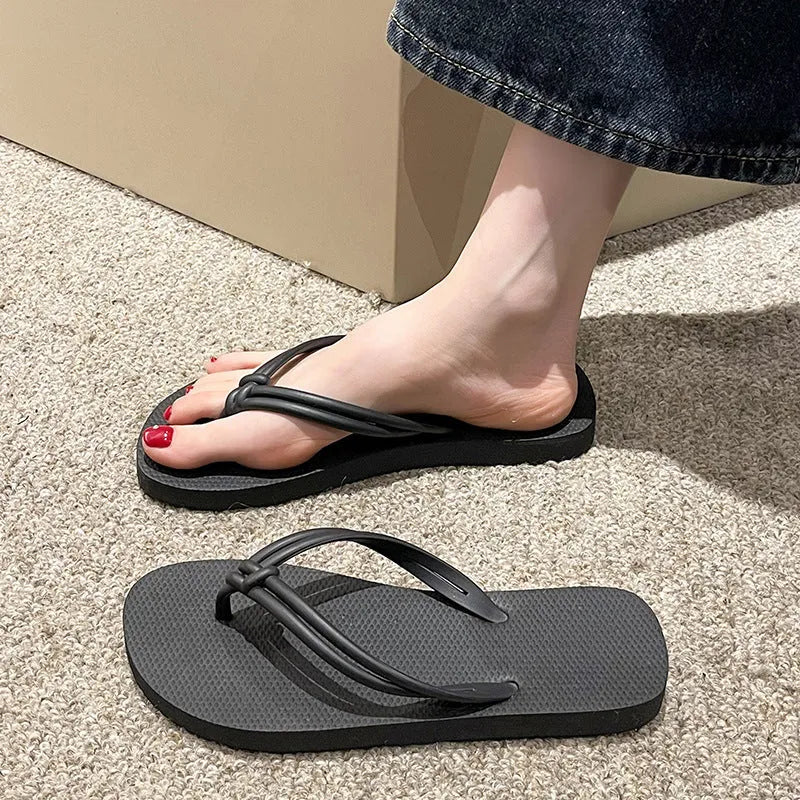 PVC women's flip flops in pink with a non-slip sole and toe-covering strap.