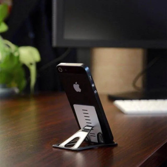 Black desktop phone holder with suction cup base showing adjustable bracket for smartphones