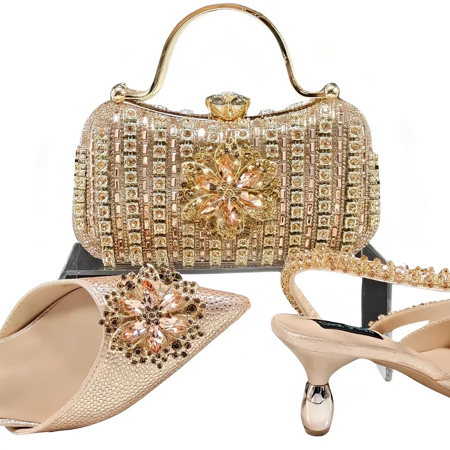Women's black high-heel shoes with decorative ankle chain featuring floral rhinestone accents and matching clutch bag