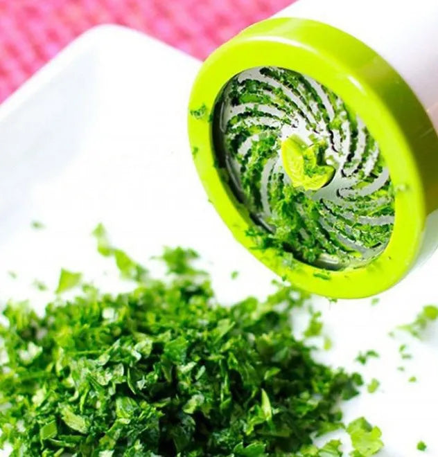 White and grey manual herb grinder with a removable top, showing stainless steel blades inside.