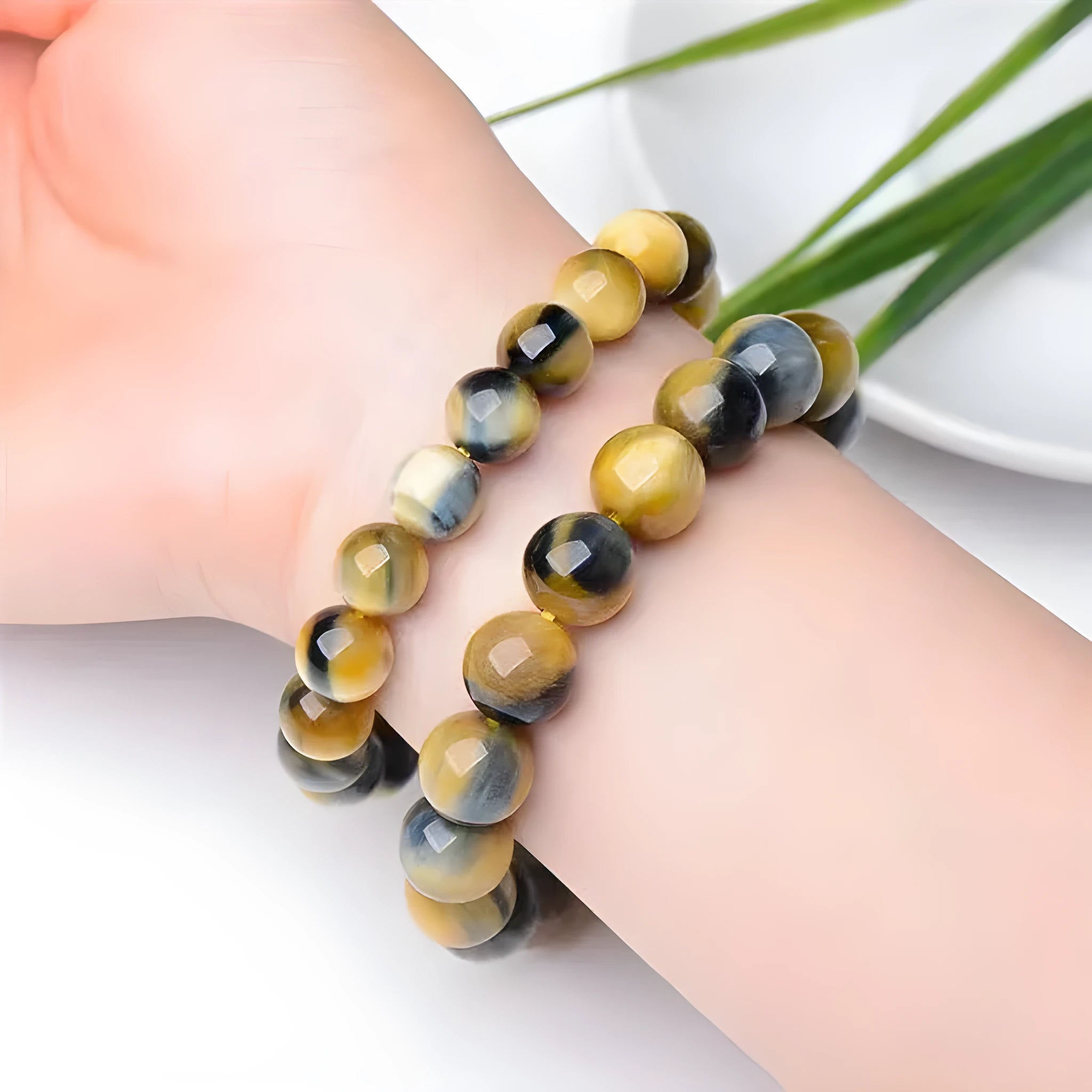 Handmade fantasy tiger eye agate beaded bracelet with 10mm round beads on a wrist.