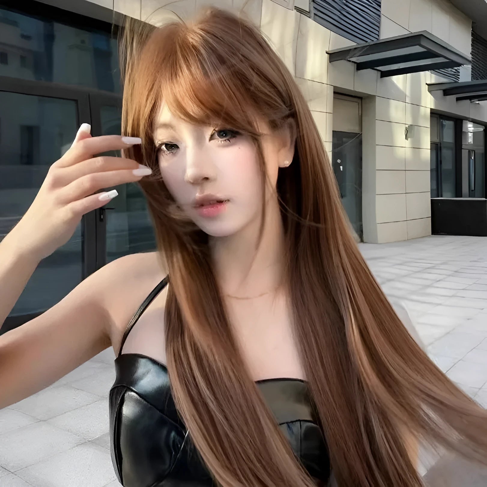 Warm tea chestnut brown long straight synthetic wig with bangs on display