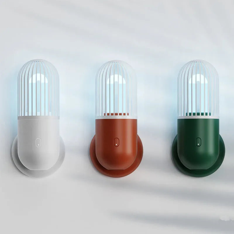 Compact portable UVC disinfection lamp in capsule design showing black, brown, green, and white colour options.