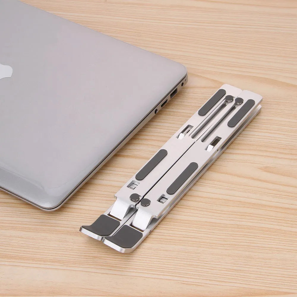 Silver folding computer stand in aluminium alloy with silicone points for laptops under 16 inches