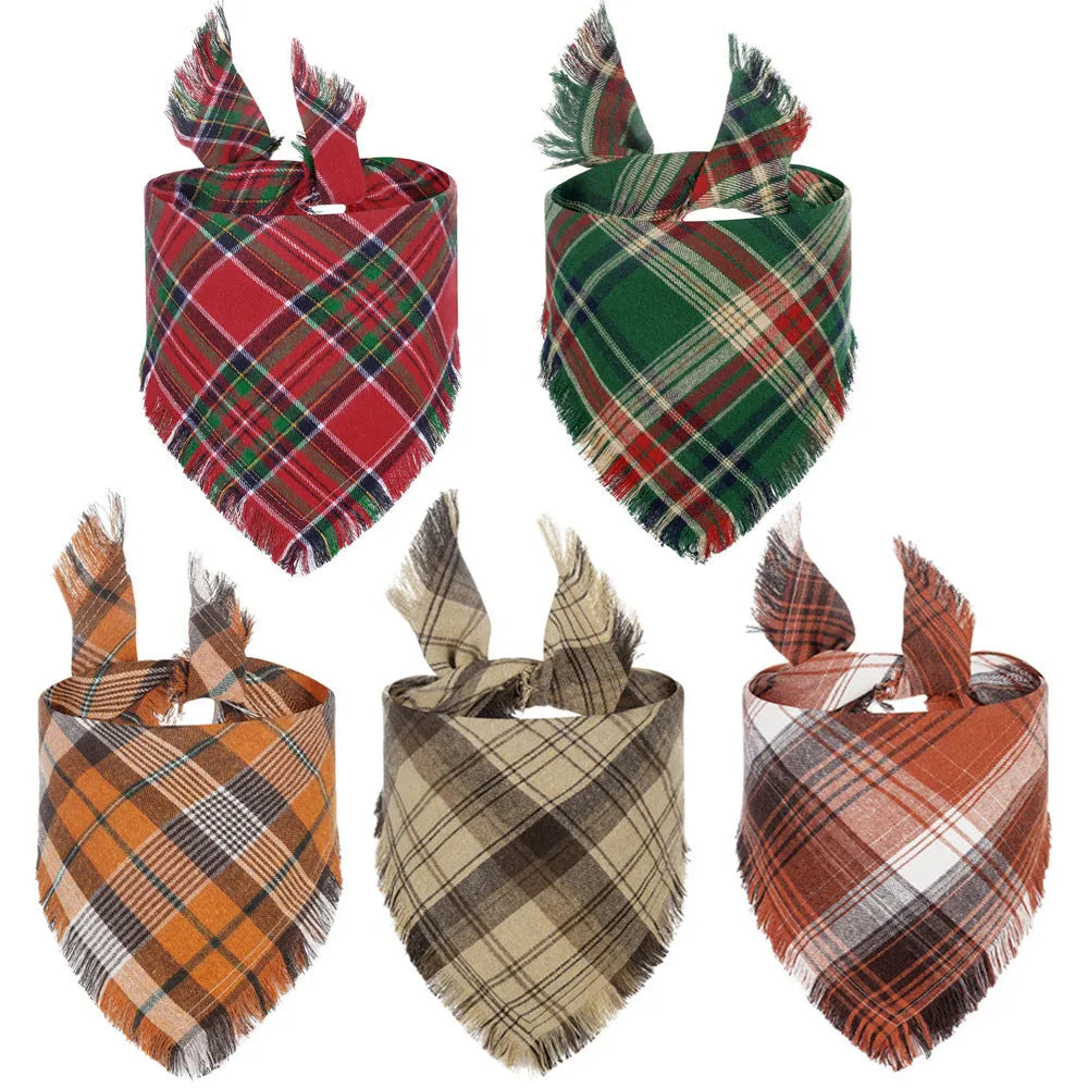Plaid triangle dog bandana with tassel edges in autumn colours on a dog's neck.
